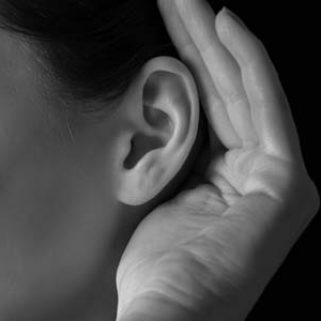 Unrecognizable woman holds her hand near ear and listens, close-up